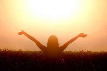 Girl lift her hands to the sky and feel freedom. Happiness and success concept.